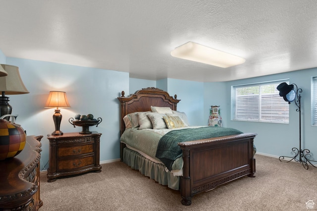 bedroom with baseboards, a textured ceiling, and carpet