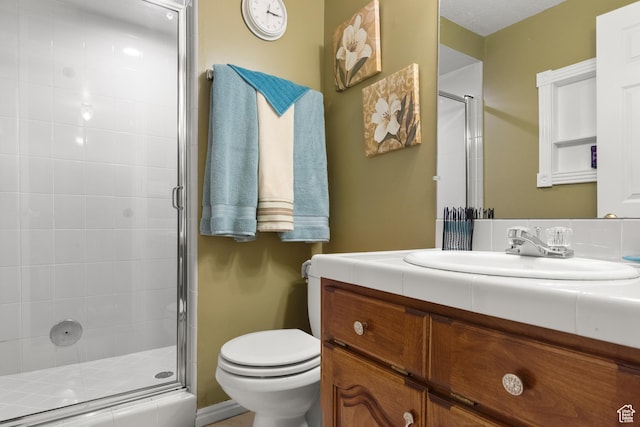 full bathroom with toilet, a shower stall, and vanity
