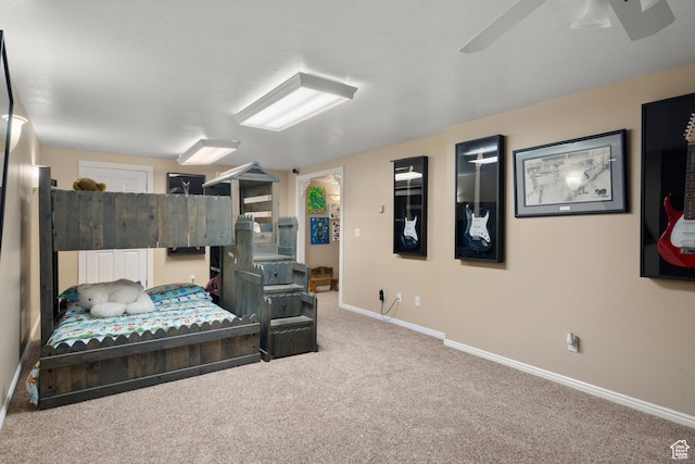 carpeted bedroom with a ceiling fan and baseboards