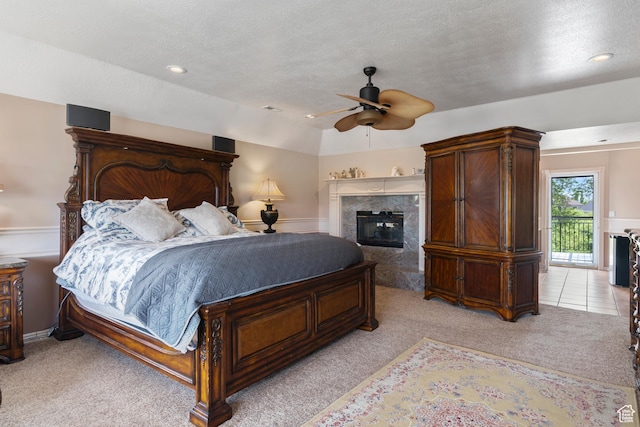 bedroom with ceiling fan, light carpet, a fireplace, a textured ceiling, and recessed lighting