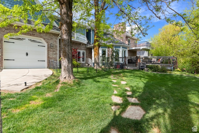 view of yard with concrete driveway, fence, french doors, and a balcony