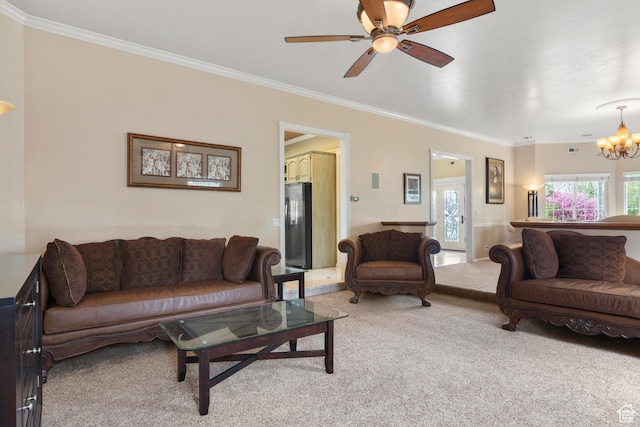 living area with ornamental molding, ceiling fan with notable chandelier, visible vents, and light colored carpet