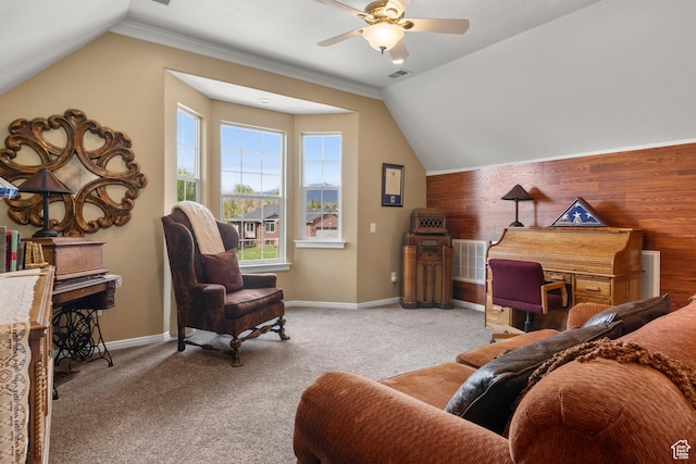 interior space with wooden walls, baseboards, visible vents, and vaulted ceiling