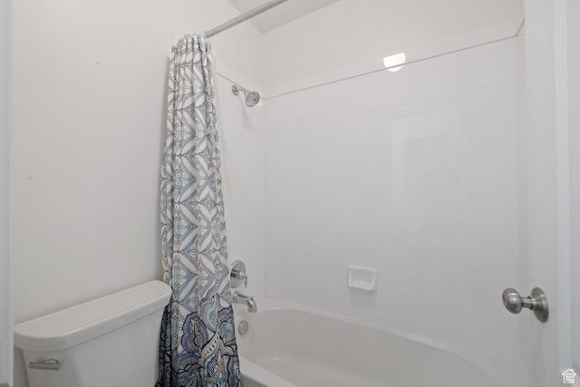 bathroom featuring toilet and shower / bathtub combination with curtain