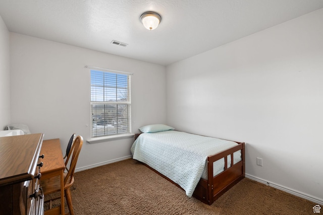 carpeted bedroom featuring baseboards and visible vents