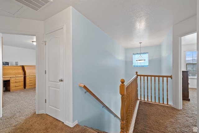stairway featuring carpet floors, baseboards, and visible vents