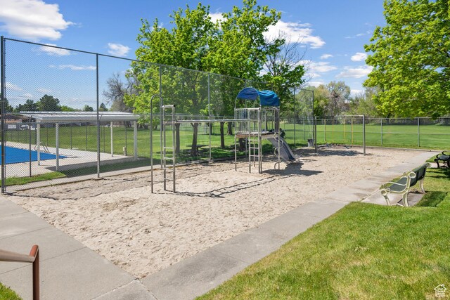 communal playground with a lawn and fence