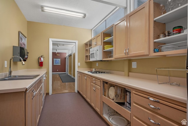 kitchen with open shelves, light brown cabinets, white appliances, light countertops, and a sink