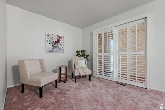 living area with carpet floors, baseboards, and visible vents