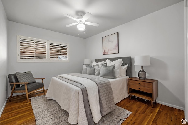 bedroom featuring baseboards, dark wood-style flooring, and ceiling fan