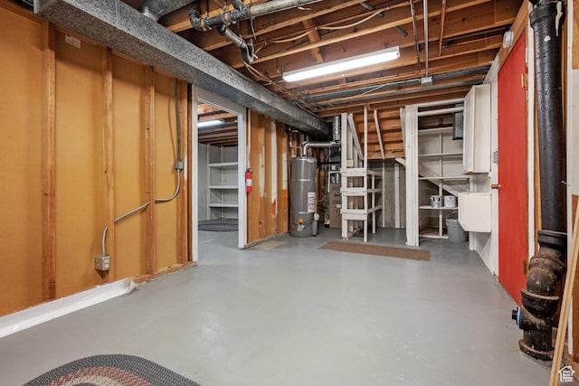 unfinished below grade area featuring water heater