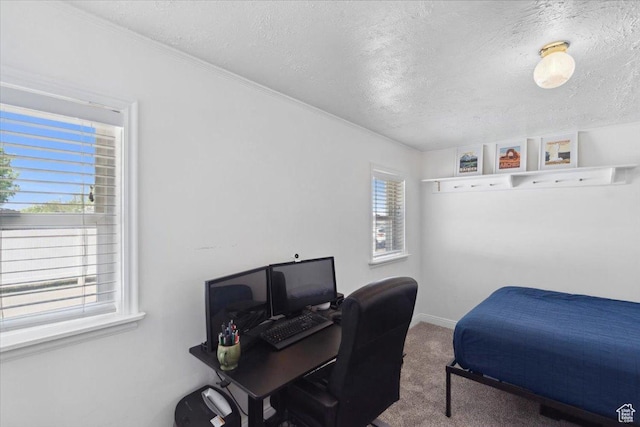carpeted bedroom with baseboards and a textured ceiling