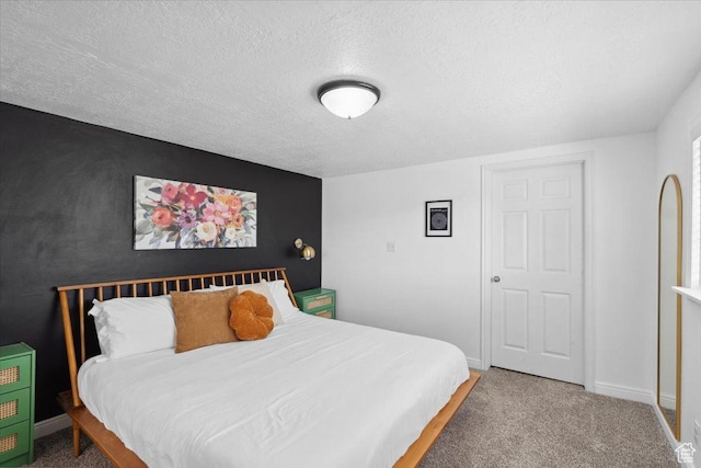 bedroom with baseboards, carpet flooring, and a textured ceiling