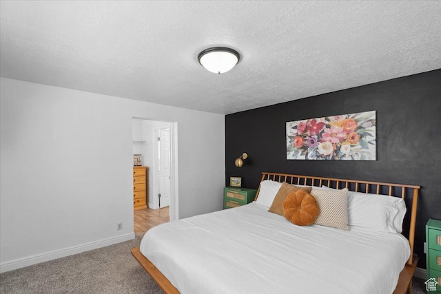 bedroom featuring carpet flooring, a textured ceiling, and baseboards