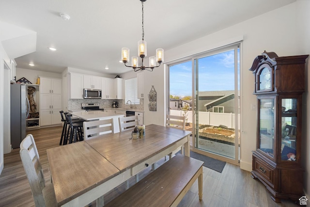 743 N 690 E, Tooele, UT 84074 - dining room featuring recessed lighting, wood finished floors, and a notable chandelier