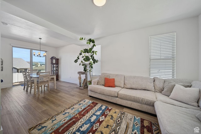 743 N 690 E, Tooele, UT 84074 - living area with baseboards, a chandelier, and wood finished floors