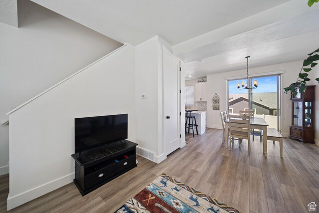 743 N 690 E, Tooele, UT 84074 - living area featuring visible vents, baseboards, wood finished floors, and a chandelier