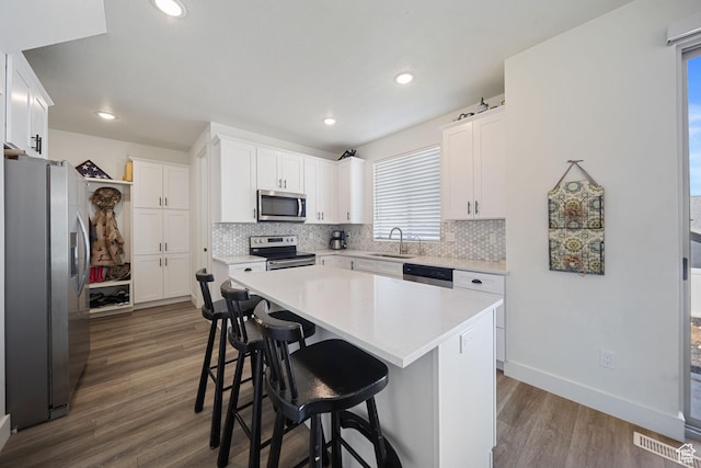 743 N 690 E, Tooele, UT 84074 - kitchen featuring backsplash, appliances with stainless steel finishes, a sink, and dark wood finished floors