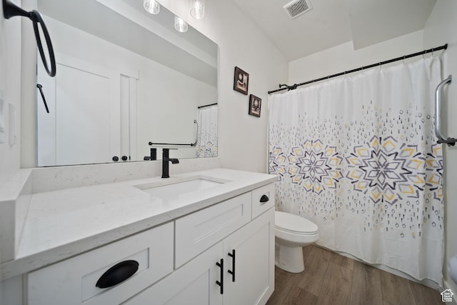 743 N 690 E, Tooele, UT 84074 - bathroom with vanity, toilet, wood finished floors, a shower with curtain, and visible vents