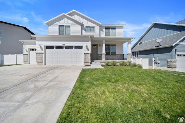 743 N 690 E, Tooele, UT 84074 - view of front of house featuring covered porch, fence, board and batten siding, and a front lawn