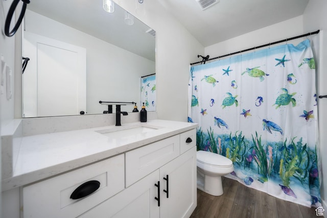 743 N 690 E, Tooele, UT 84074 - bathroom featuring visible vents, vanity, curtained shower, wood finished floors, and toilet
