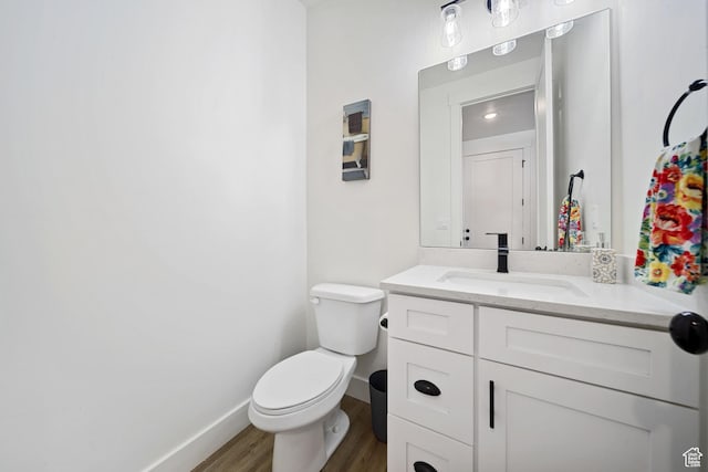 743 N 690 E, Tooele, UT 84074 - bathroom featuring vanity, baseboards, wood finished floors, and toilet