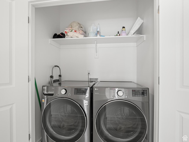 clothes washing area with separate washer and dryer
