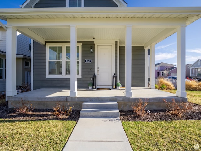 view of exterior entry featuring a residential view and covered porch