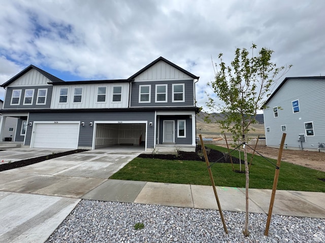 3620 N Stallion St Unit 349, Eagle Mountain, UT 84005 - view of front facade with board and batten siding, an attached garage, and concrete driveway