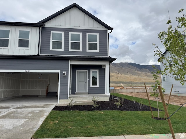 3620 N Stallion St Unit 349, Eagle Mountain, UT 84005 - view of front of home featuring board and batten siding, a mountain view, a front yard, and an attached garage