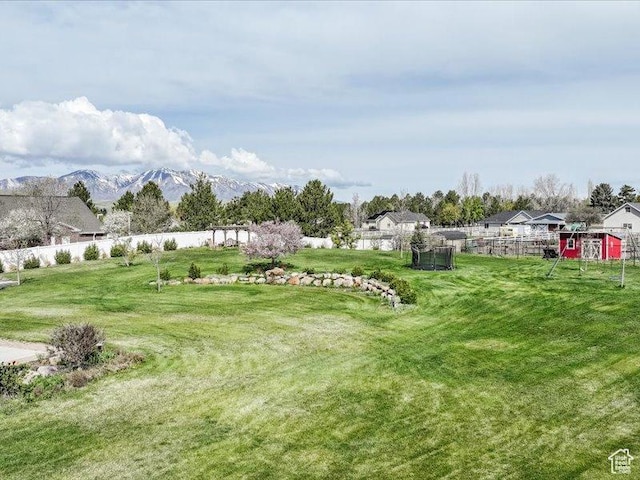 view of yard with fence and a mountain view