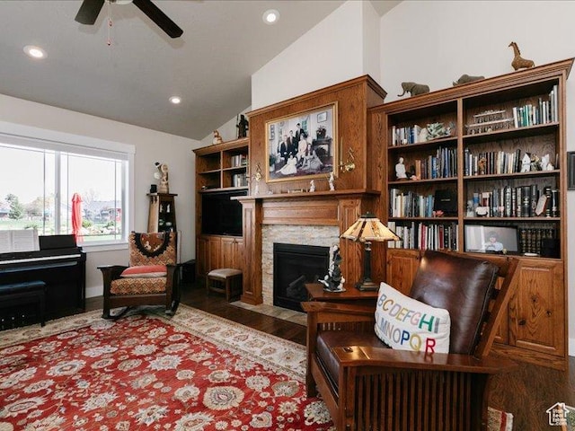 sitting room featuring a ceiling fan, a fireplace with flush hearth, wood finished floors, lofted ceiling, and recessed lighting