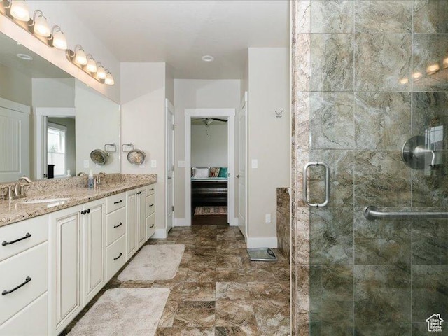full bathroom featuring vanity, baseboards, and a stall shower