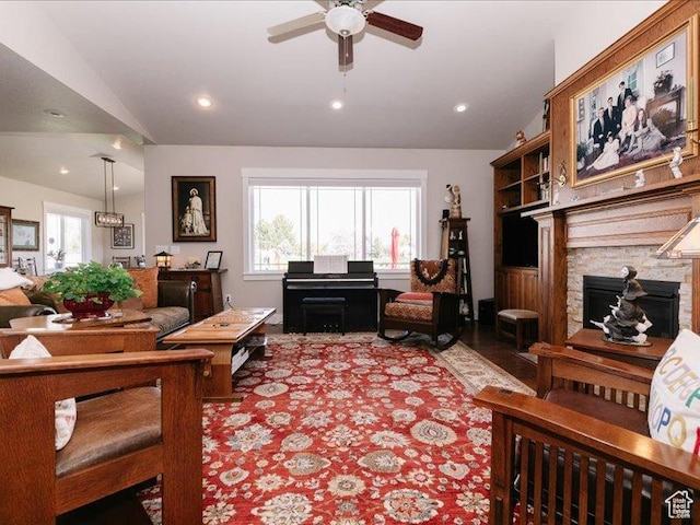 living area with recessed lighting, a ceiling fan, vaulted ceiling, and a fireplace