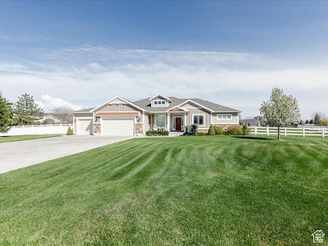 craftsman house featuring concrete driveway, an attached garage, fence, and a front lawn