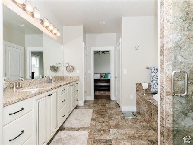 bathroom with a sink, a bath, a shower with shower door, and double vanity