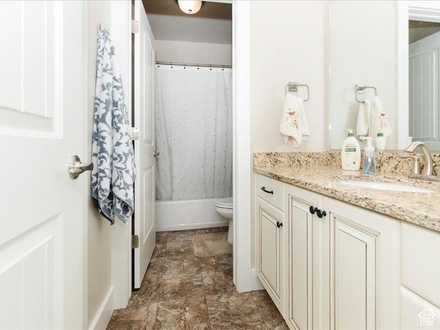 bathroom with vanity, stone finish floor, toilet, and shower / bath combination with curtain