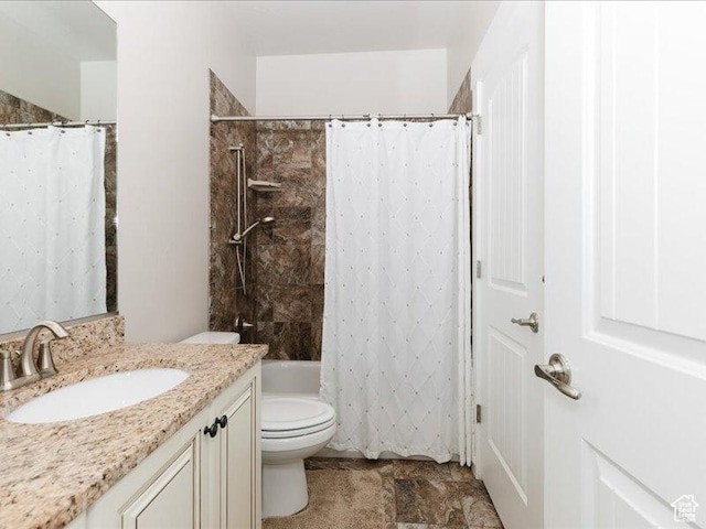 full bath featuring vanity, shower / bath combo, and toilet