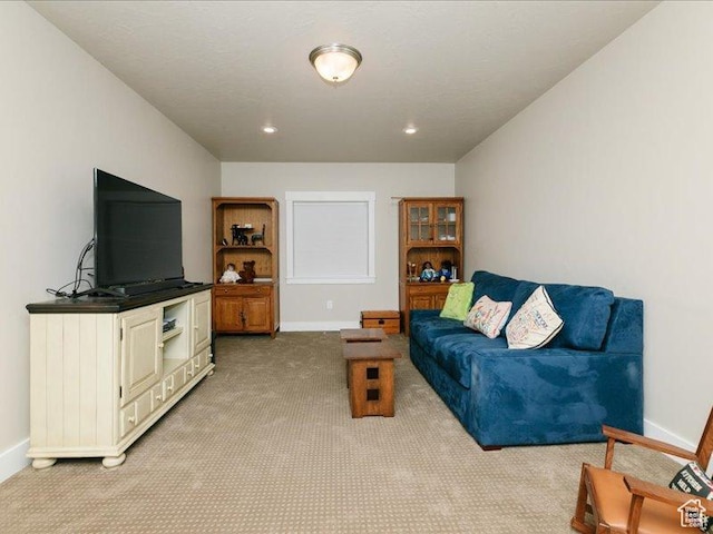 living room featuring baseboards, recessed lighting, and light colored carpet