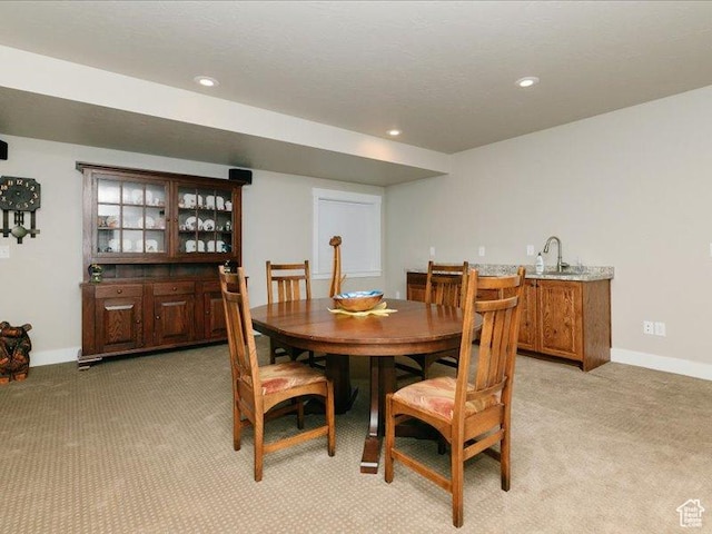 dining area with recessed lighting, baseboards, and light carpet