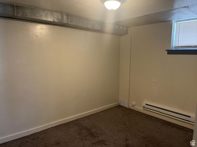 953 E 24th St, Ogden, UT 84401 - empty room with a baseboard radiator, dark colored carpet, and baseboards