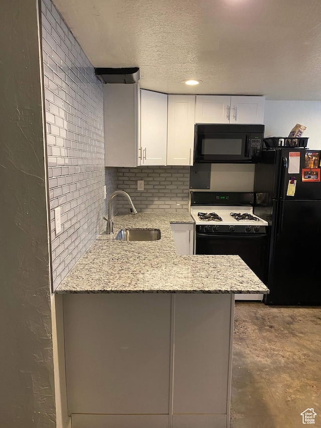953 E 24th St, Ogden, UT 84401 - kitchen featuring a sink, a textured ceiling, light stone counters, black appliances, and white cabinetry