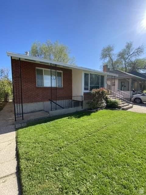 953 E 24th St, Ogden, UT 84401 - single story home with a chimney, brick siding, and a front lawn