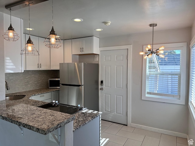 953 E 24th St, Ogden, UT 84401 - kitchen featuring a sink, dark stone countertops, backsplash, stainless steel appliances, and white cabinets