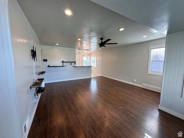953 E 24th St, Ogden, UT 84401 - unfurnished living room featuring a ceiling fan, baseboards, visible vents, and dark wood-style floors