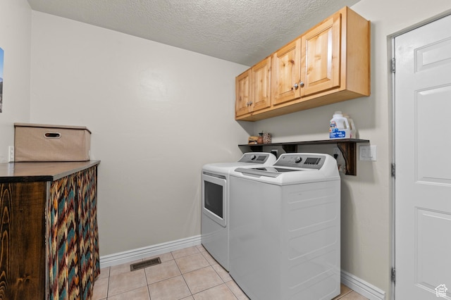 294 W Farmside Dr S, Saratoga Springs, UT 84045 - clothes washing area featuring cabinet space, washing machine and clothes dryer, baseboards, light tile patterned flooring, and a textured ceiling