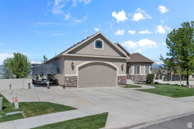294 W Farmside Dr S, Saratoga Springs, UT 84045 - view of front facade with stucco siding, stone siding, driveway, and an attached garage