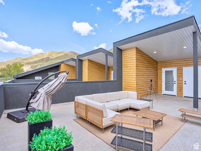 view of patio featuring an outdoor living space and a mountain view