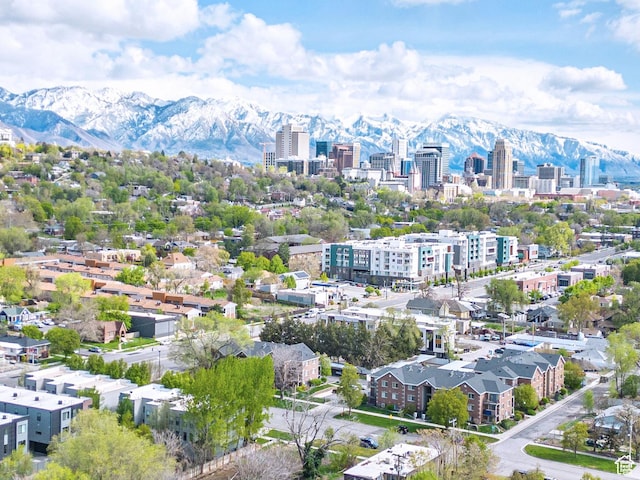 drone / aerial view featuring a mountain view and a city view