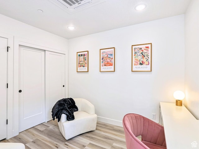 living area with recessed lighting, light wood finished floors, and baseboards